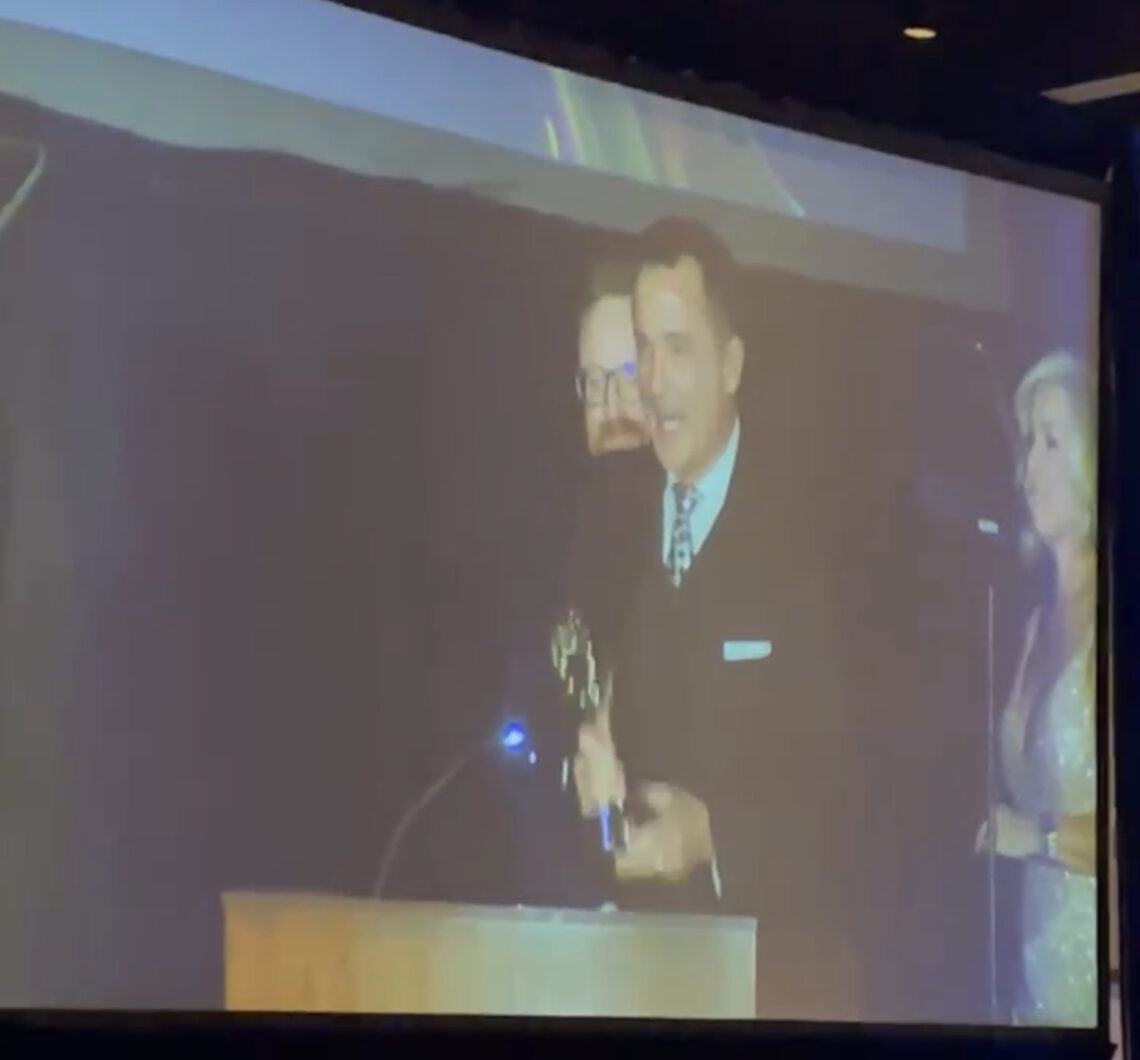 FOX 35's John Brown accepts an Emmy Award for Disney's 50th Anniversary special